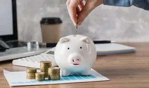 hand-putting-coin-piggy-bank-growth-chart